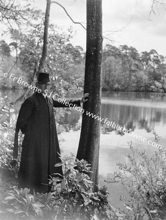 REV T COUNIHAN S.J. BESIDE LAKE AT ST MARY'S EMO